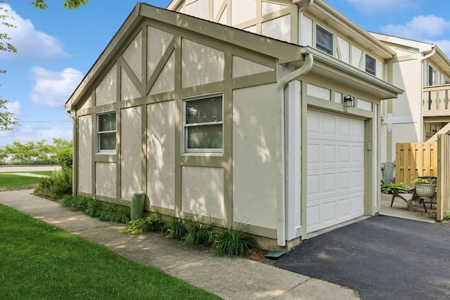 830 E Hillside Ave Unit 830, Barrington, IL 60010 - view of side of home featuring stucco siding, driveway, and a garage