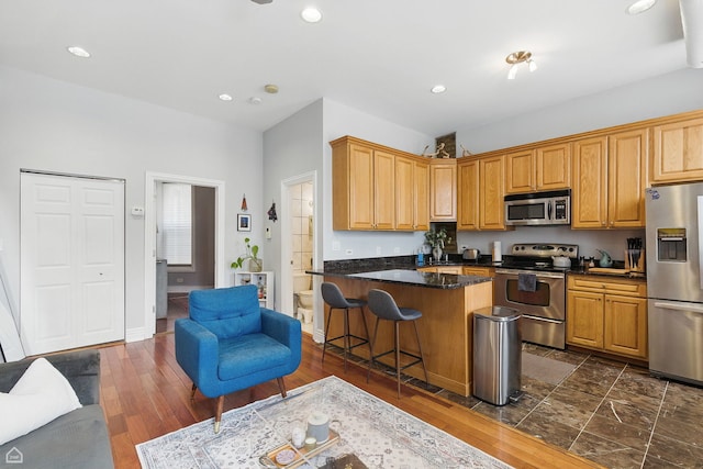 2212 N Campbell Ave Unit 1D, Chicago, IL 60647 - kitchen with stainless steel appliances, recessed lighting, a breakfast bar area, dark wood-style flooring, and a sink