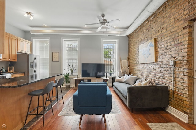 2212 N Campbell Ave Unit 1D, Chicago, IL 60647 - living area with brick wall, a ceiling fan, hardwood / wood-style flooring, and baseboards