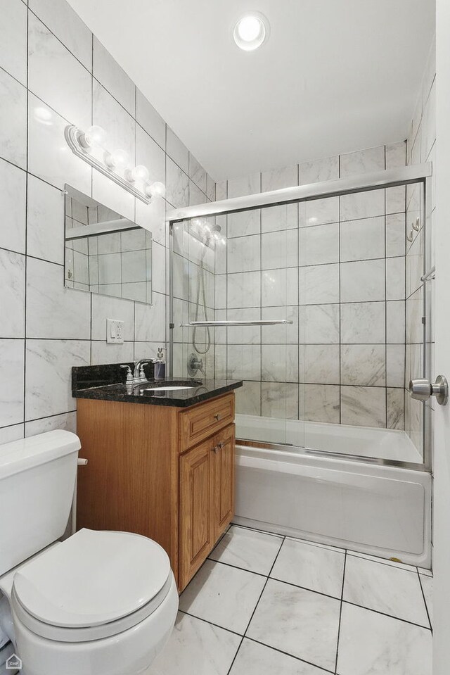 2212 N Campbell Ave Unit 1D, Chicago, IL 60647 - bathroom with toilet, vanity, bath / shower combo with glass door, and tile walls