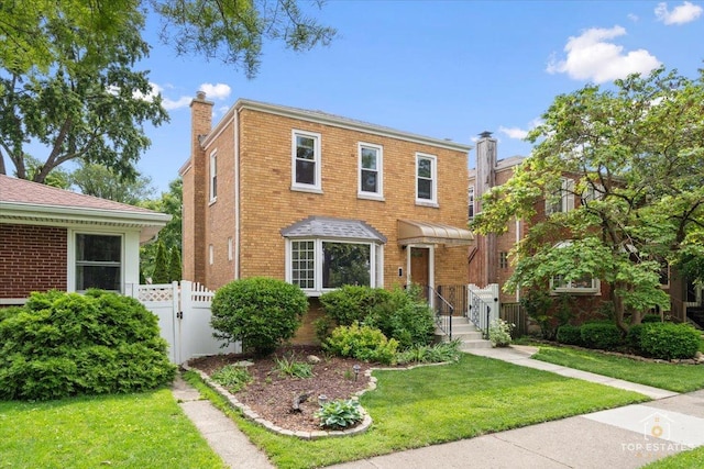1176 S Maple Ave, Oak Park, IL 60304 - view of front of property featuring a chimney, brick siding, and a gate