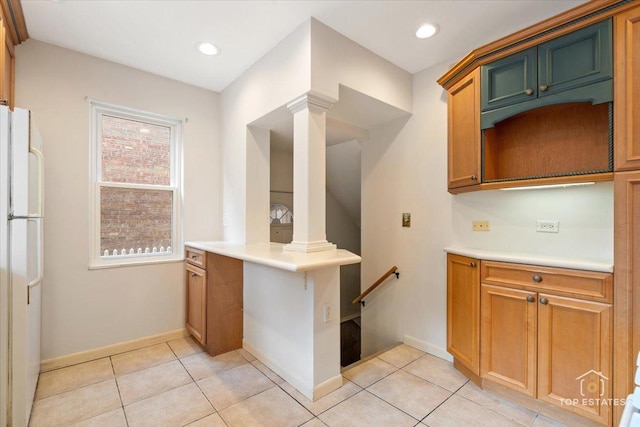 1176 S Maple Ave, Oak Park, IL 60304 - kitchen with freestanding refrigerator, ornate columns, light countertops, light tile patterned floors, and recessed lighting