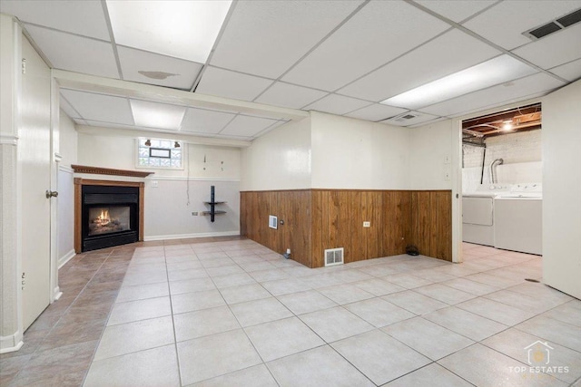 1176 S Maple Ave, Oak Park, IL 60304 - basement with a wainscoted wall, a paneled ceiling, a warm lit fireplace, wooden walls, and separate washer and dryer
