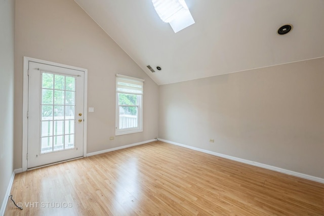 1949 N Charter Point Dr Unit 0, Arlington Heights, IL 60004 - spare room featuring a skylight, lofted ceiling, light wood-style flooring, and baseboards