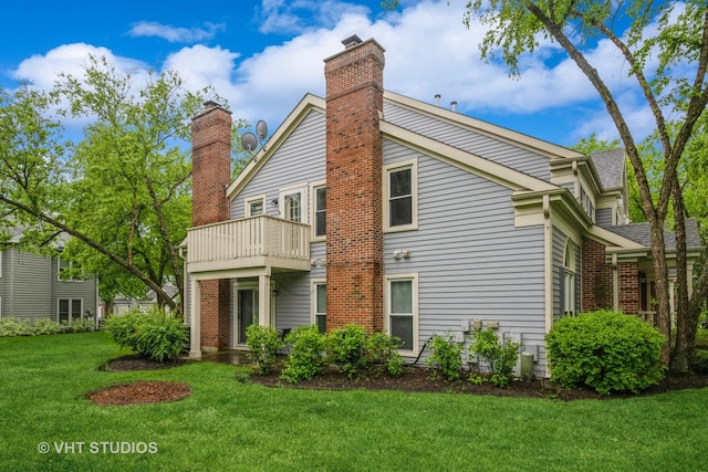1949 N Charter Point Dr Unit 0, Arlington Heights, IL 60004 - rear view of property featuring a chimney, a balcony, and a yard