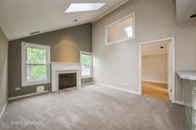 1949 N Charter Point Dr Unit 0, Arlington Heights, IL 60004 - unfurnished living room with vaulted ceiling, a skylight, carpet floors, a tiled fireplace, and baseboards