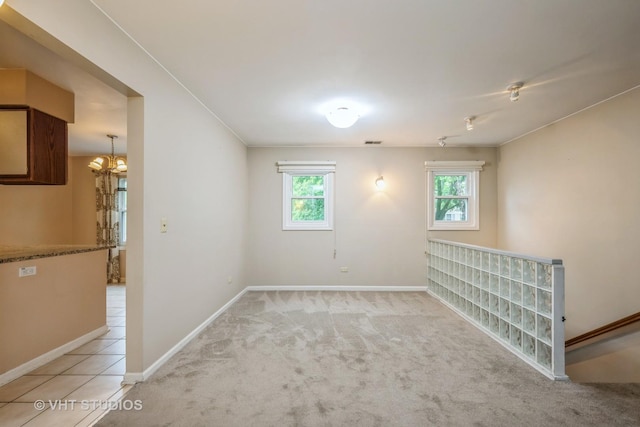 1949 N Charter Point Dr Unit 0, Arlington Heights, IL 60004 - unfurnished room featuring healthy amount of natural light, baseboards, light colored carpet, and a chandelier