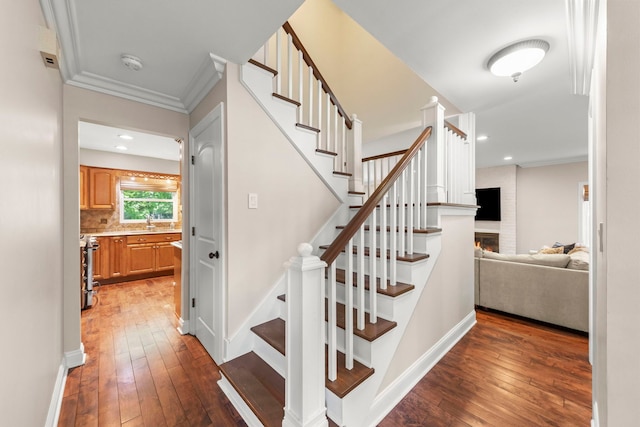 389 Pearson Cir, Naperville, IL 60563 - staircase with hardwood / wood-style flooring, a fireplace, crown molding, and recessed lighting