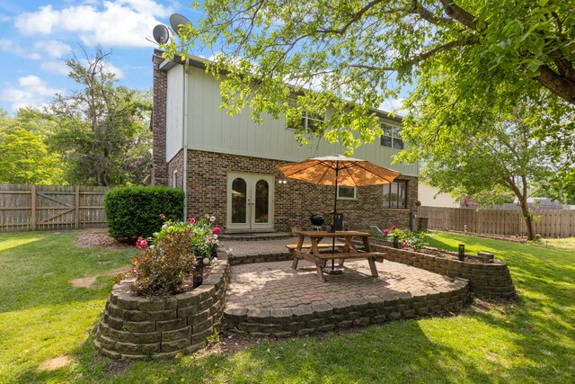 389 Pearson Cir, Naperville, IL 60563 - rear view of house with brick siding, a patio, a fenced backyard, a chimney, and french doors