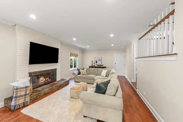 389 Pearson Cir, Naperville, IL 60563 - living room with wood finished floors, a brick fireplace, crown molding, and recessed lighting