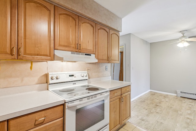 241 Northway Park Rd Unit 10, Machesney Park, IL 61115 - kitchen with white range with electric stovetop, under cabinet range hood, light countertops, a ceiling fan, and a baseboard radiator