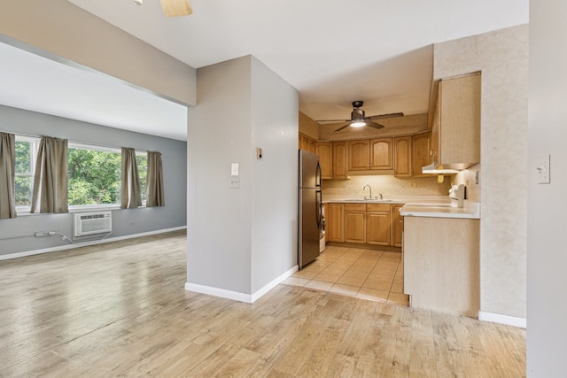 241 Northway Park Rd Unit 10, Machesney Park, IL 61115 - kitchen featuring a ceiling fan, freestanding refrigerator, a sink, and light wood-type flooring