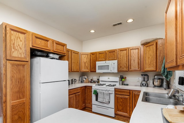 3134 S Morgan St, Chicago, IL 60608 - kitchen with white appliances, a sink, light countertops, recessed lighting, and brown cabinets