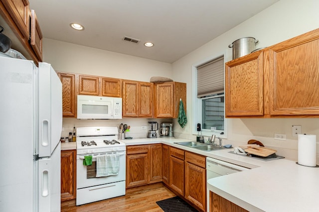 3134 S Morgan St, Chicago, IL 60608 - kitchen with white appliances, a sink, light countertops, light wood-style floors, and recessed lighting