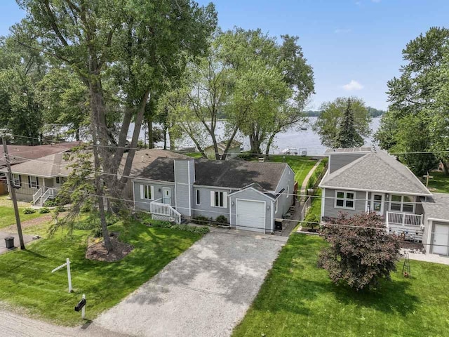35632 N Sheridan Dr, Fox Lake, IL 60020 - view of front of home featuring asphalt driveway, a front lawn, and a garage