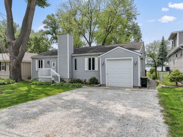 35632 N Sheridan Dr, Fox Lake, IL 60020 - single story home featuring an attached garage, a chimney, gravel driveway, and a front yard