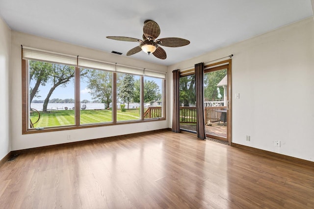35632 N Sheridan Dr, Fox Lake, IL 60020 - unfurnished room with a water view, wood finished floors, and a ceiling fan