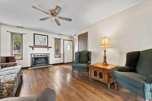 35632 N Sheridan Dr, Fox Lake, IL 60020 - living room with healthy amount of natural light, wood finished floors, a fireplace with flush hearth, and ceiling fan