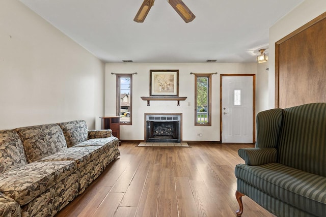 35632 N Sheridan Dr, Fox Lake, IL 60020 - living area featuring healthy amount of natural light, a ceiling fan, wood finished floors, and a fireplace