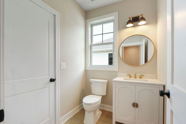 571 Mill St Unit 2, Fontana, WI 53125 - half bath with toilet, vanity, baseboards, and wood finished floors