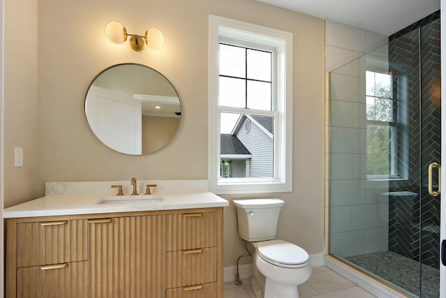 571 Mill St Unit 2, Fontana, WI 53125 - bathroom with toilet, vanity, a shower stall, tile patterned flooring, and baseboards
