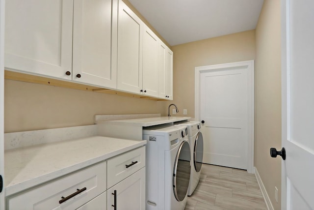 571 Mill St Unit 2, Fontana, WI 53125 - washroom with cabinet space, washing machine and clothes dryer, and baseboards