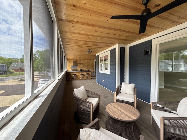 571 Mill St Unit 2, Fontana, WI 53125 - sunroom / solarium with wood ceiling, wooden walls, ceiling fan, and vaulted ceiling