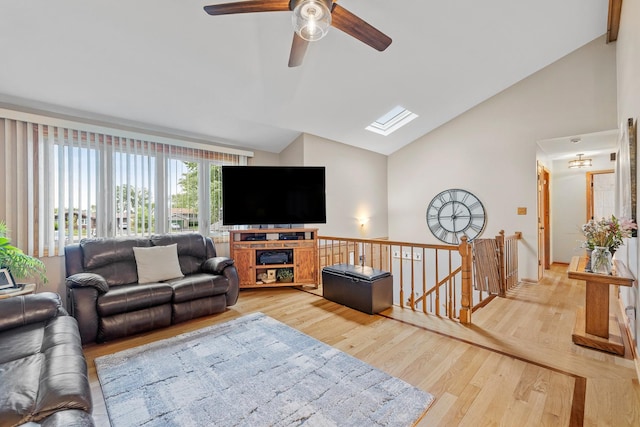 13641 W Ironwood Cir, Homer Glen, IL 60491 - living area featuring a skylight, light wood-type flooring, a ceiling fan, and high vaulted ceiling