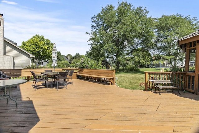 3560 Jeremy Ranch Ct, Naperville, IL 60564 - wooden terrace featuring outdoor dining area, a yard, and a trampoline