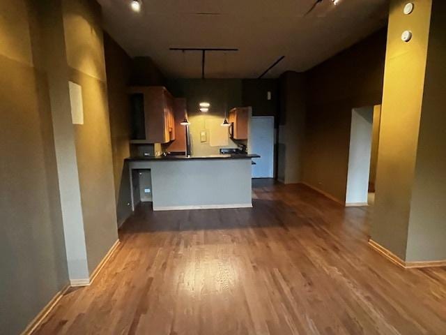 600 S Dearborn St Unit 308, Chicago, IL 60605 - kitchen with dark countertops, rail lighting, wood finished floors, open floor plan, and baseboards