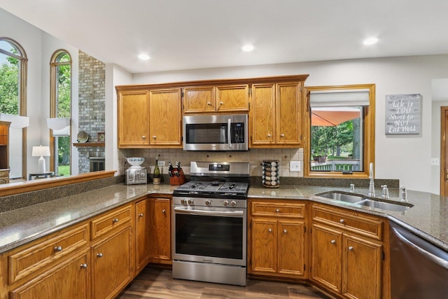 11624 Kluth Ct, Mokena, IL 60448 - kitchen with appliances with stainless steel finishes, brown cabinets, backsplash, dark wood-type flooring, and recessed lighting