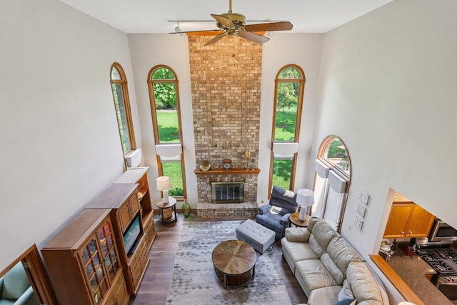 11624 Kluth Ct, Mokena, IL 60448 - living room featuring a fireplace, a ceiling fan, dark wood-style floors, and a high ceiling