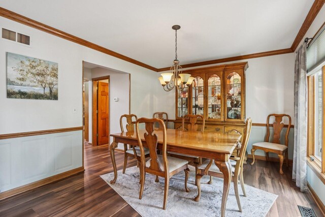 11624 Kluth Ct, Mokena, IL 60448 - dining area with dark wood-style flooring, a chandelier, and crown molding