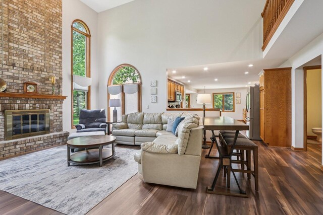 11624 Kluth Ct, Mokena, IL 60448 - living area featuring a high ceiling, dark wood-style floors, recessed lighting, and a brick fireplace