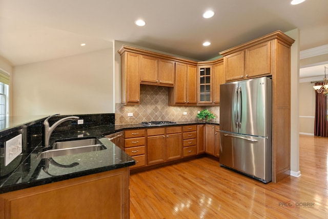 3 Joshua Ct, South Barrington, IL 60010 - kitchen with appliances with stainless steel finishes, a sink, brown cabinetry, tasteful backsplash, and dark stone countertops