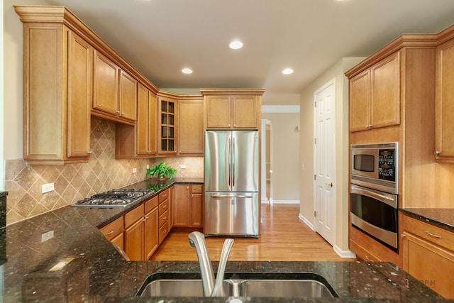 3 Joshua Ct, South Barrington, IL 60010 - kitchen featuring stainless steel appliances, a sink, dark stone counters, light wood-style floors, and glass insert cabinets