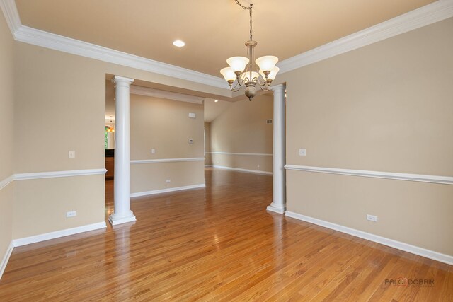 3 Joshua Ct, South Barrington, IL 60010 - spare room with a chandelier, ornamental molding, baseboards, light wood-type flooring, and ornate columns