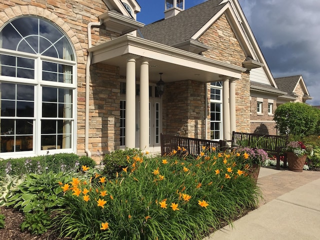 3 Joshua Ct, South Barrington, IL 60010 - doorway to property featuring stone siding, covered porch, roof with shingles, and brick siding