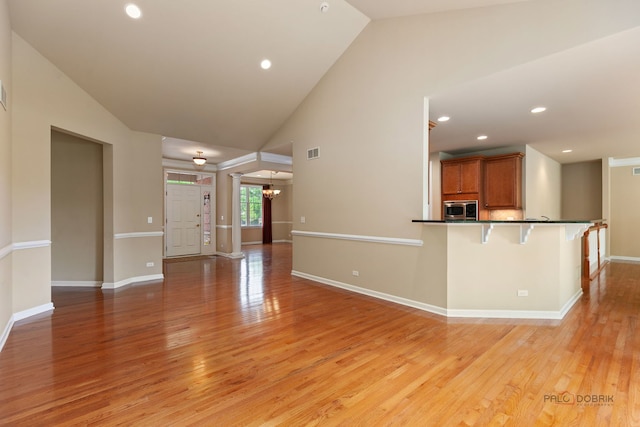 3 Joshua Ct, South Barrington, IL 60010 - unfurnished living room with light wood-style flooring, baseboards, recessed lighting, a chandelier, and high vaulted ceiling