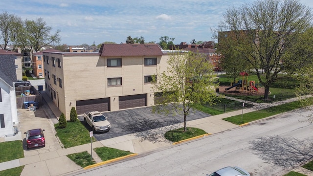 1258 Brown St Unit 204, Des Plaines, IL 60016 - view of property with a garage and driveway