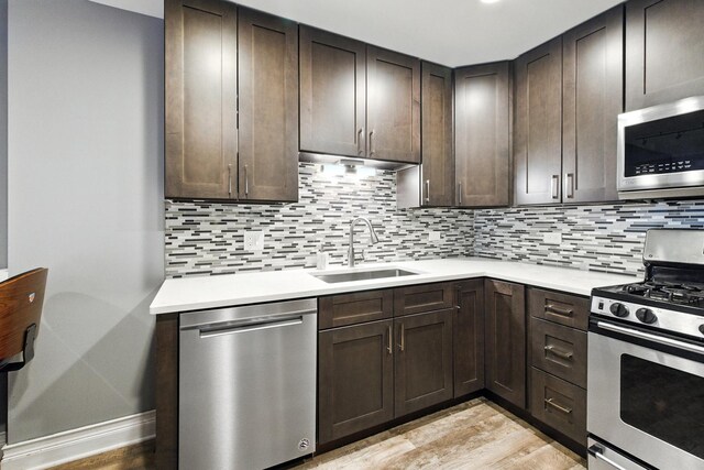 1258 Brown St Unit 204, Des Plaines, IL 60016 - kitchen with appliances with stainless steel finishes, light wood-type flooring, light countertops, and dark brown cabinetry