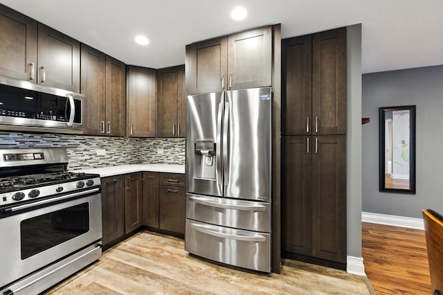 1258 Brown St Unit 204, Des Plaines, IL 60016 - kitchen with appliances with stainless steel finishes, light wood-type flooring, dark brown cabinets, decorative backsplash, and recessed lighting