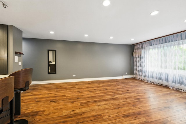 1258 Brown St Unit 204, Des Plaines, IL 60016 - unfurnished living room featuring wood finished floors, recessed lighting, and a baseboard radiator