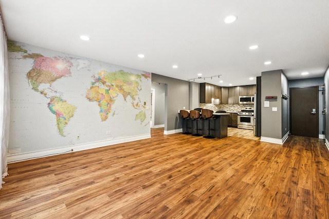 1258 Brown St Unit 204, Des Plaines, IL 60016 - kitchen with appliances with stainless steel finishes, light countertops, light wood-type flooring, decorative backsplash, and recessed lighting
