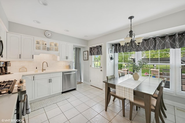 2734 N Dryden Pl, Arlington Heights, IL 60004 - kitchen featuring stainless steel appliances, a sink, a chandelier, white cabinets, and light countertops