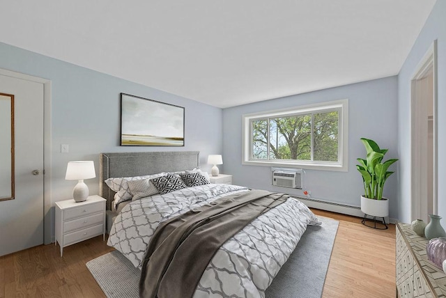 1050 W Columbia Ave Unit 3H, Chicago, IL 60626 - bedroom featuring an AC wall unit, wood finished floors, and a baseboard radiator