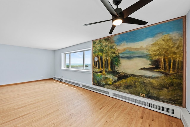 1050 W Columbia Ave Unit 3H, Chicago, IL 60626 - unfurnished room featuring a baseboard heating unit, wood finished floors, a ceiling fan, and baseboards