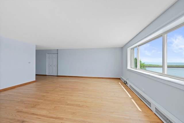 1050 W Columbia Ave Unit 3H, Chicago, IL 60626 - spare room featuring a baseboard radiator, light wood finished floors, a water view, and baseboards