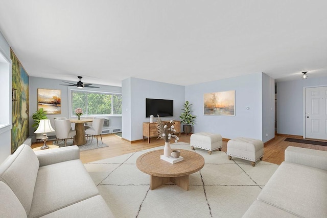 1050 W Columbia Ave Unit 3H, Chicago, IL 60626 - living room featuring wood finished floors, a ceiling fan, and baseboards