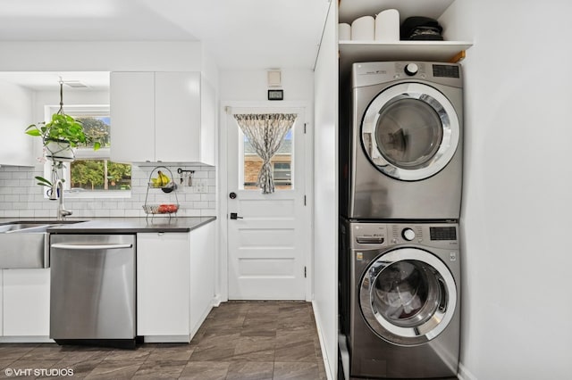 9519 Kolmar Ave, Skokie, IL 60076 - laundry room featuring stacked washer and clothes dryer and a sink